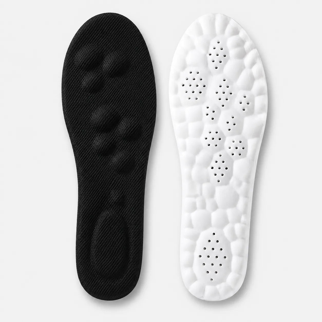 Black and white shoe insoles on a light gray background