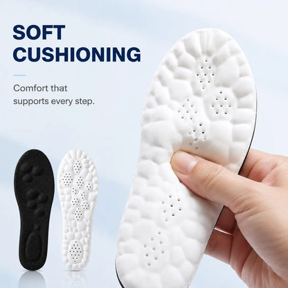 White shoe insole with soft cushioning held by a hand, with black insole for comparison on a light blue background.