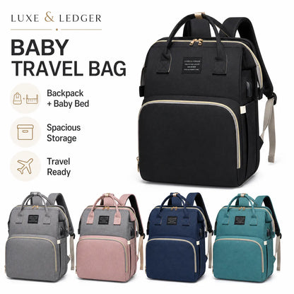 Black baby travel bag with additional bags in gray, pink, blue, and teal on a white background.