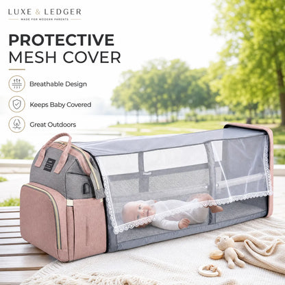 Baby travel cot with protective mesh cover in a park setting, featuring Luxe & Ledger branding.