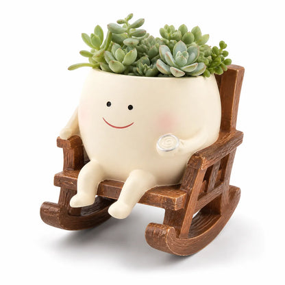 Decorative planter with a smiling face sitting in a rocking chair on a white background
