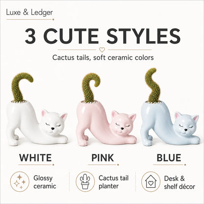 Three ceramic cat-shaped planters in white, pink, and blue with cactus tails on a white background.