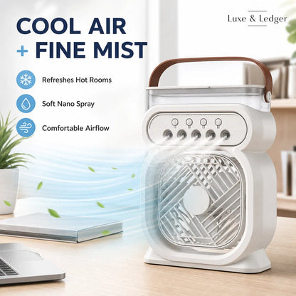 Portable air cooler with fine mist feature on a desk with laptop and plant.