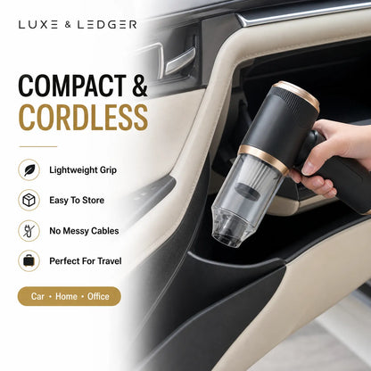 Compact cordless vacuum cleaner being used in a car with Luxe & Ledger branding.
