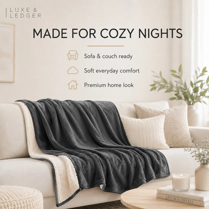 Gray blanket draped over a white sofa with 'Luxe & Ledger' branding and text about comfort and coziness.