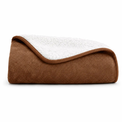 Brown and white quilted blanket on a white background