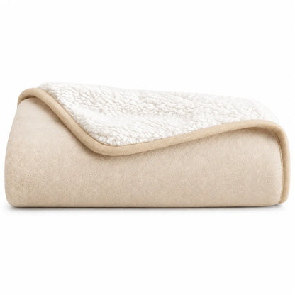 Folded blanket with cream-colored exterior and white interior on a white background