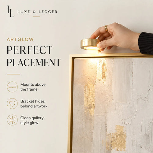 Hand adjusting a light fixture above artwork with 'Luxe & Ledger' branding.