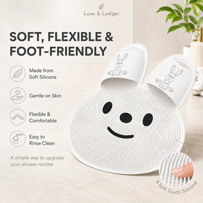 White silicone bath mat with smiley face design on a light background, featuring Luxe & Ledger branding.