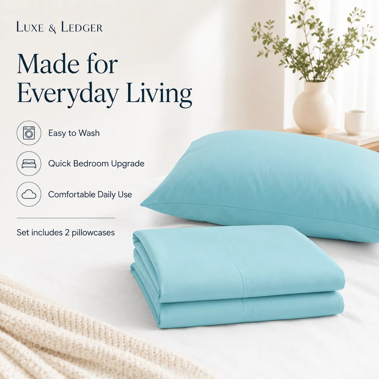 Light blue bedding set with pillows and folded sheet on a bed, featuring Luxe & Ledger branding.