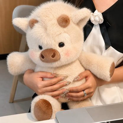 Person holding a plush pig toy in an office setting