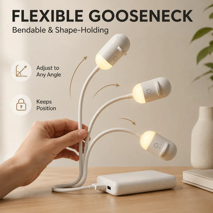 Flexible gooseneck lamp with multiple light bulbs on a wooden surface.