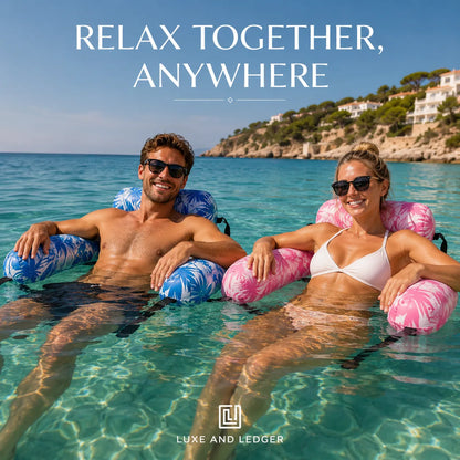 Two people lounging in the water with inflatable rings, surrounded by a scenic coastal view.
