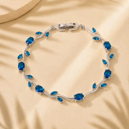 Silver bracelet with blue gemstones on a beige background