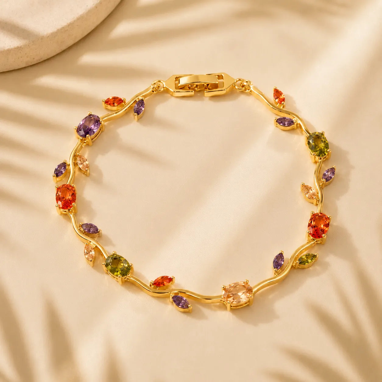 Gold bracelet with multicolored gemstones on a beige fabric background