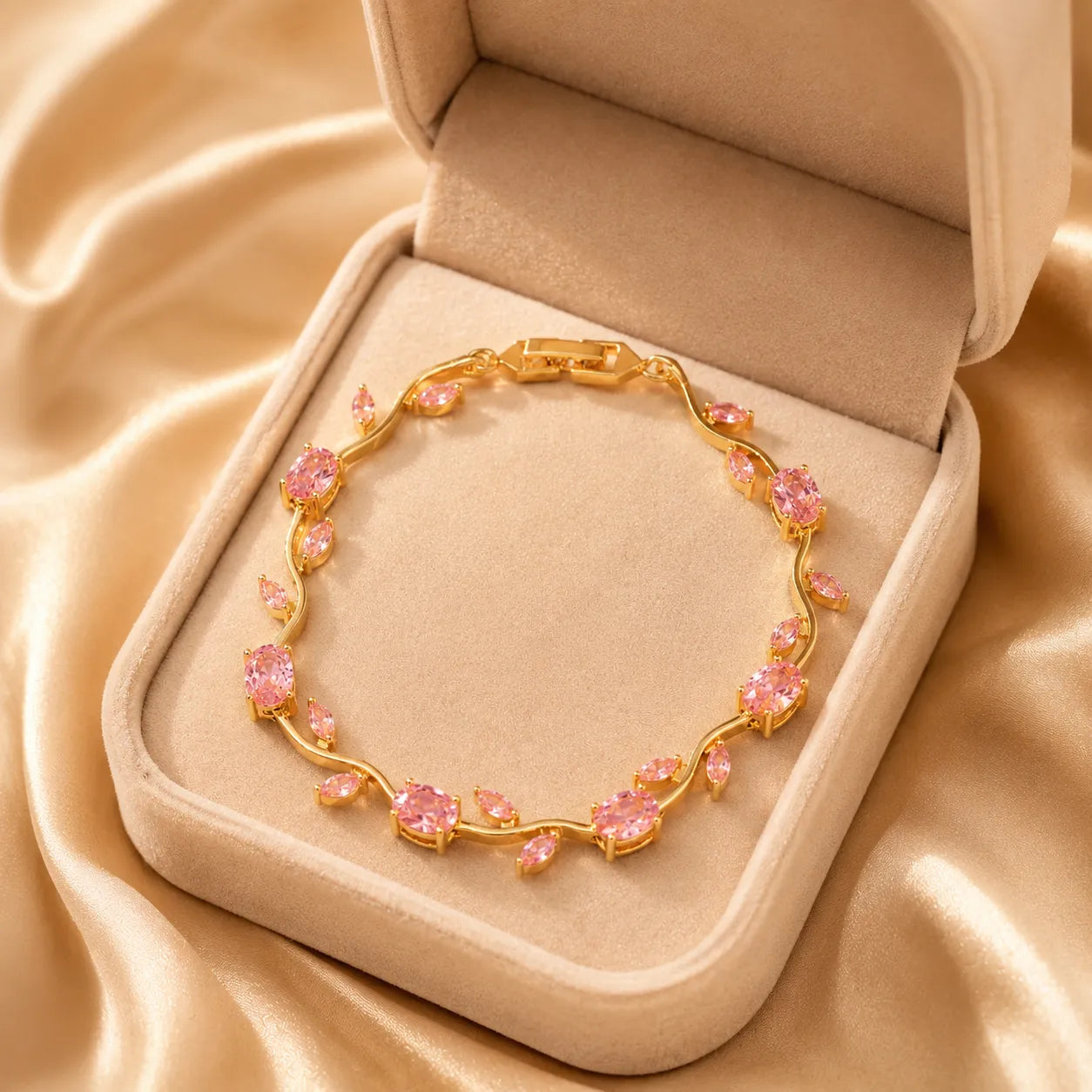 Gold bracelet with pink stones in a jewelry box on beige fabric