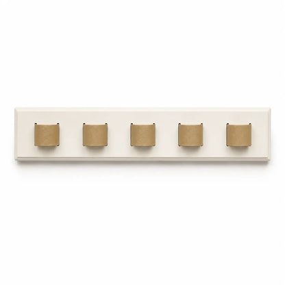 Wall-mounted coat rack with five gold hooks on a white background