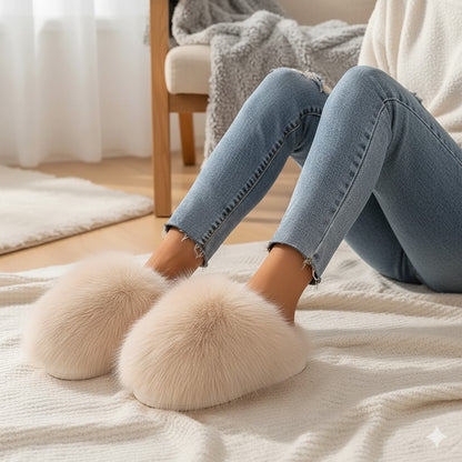 Person wearing fluffy slippers on a cozy blanket with a soft interior background