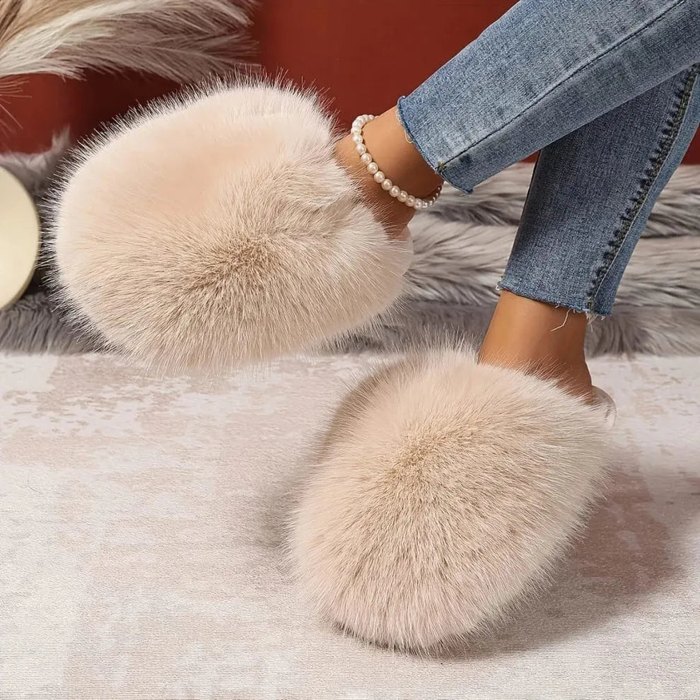 Close-up of feet wearing fluffy slippers on a soft surface