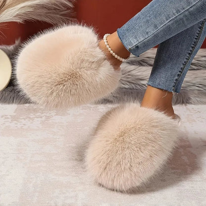 Close-up of feet wearing fluffy slippers on a soft surface