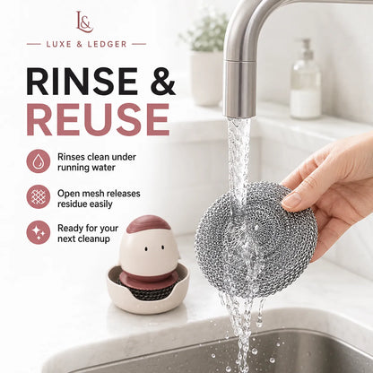 A hand holds a reusable steel wire dish scrubber under running water from a faucet in a kitchen sink, with a small character-shaped dish cleaner resting on the counter. Text on the left reads 'LUXE & LEDGER' and 'RINSE & REUSE' with feature icons.