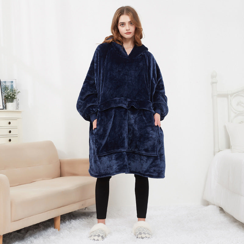 Woman wearing a navy blue fleece poncho in a living room setting