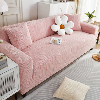 Pink sofa with a decorative flower pillow in a living room setting