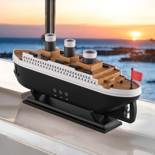 A retro ship-inspired ultrasonic humidifier, resembling the Titanic, in a room with a sunset backdrop. The humidifier is black and white with brown accents and is turned on, emitting mist.