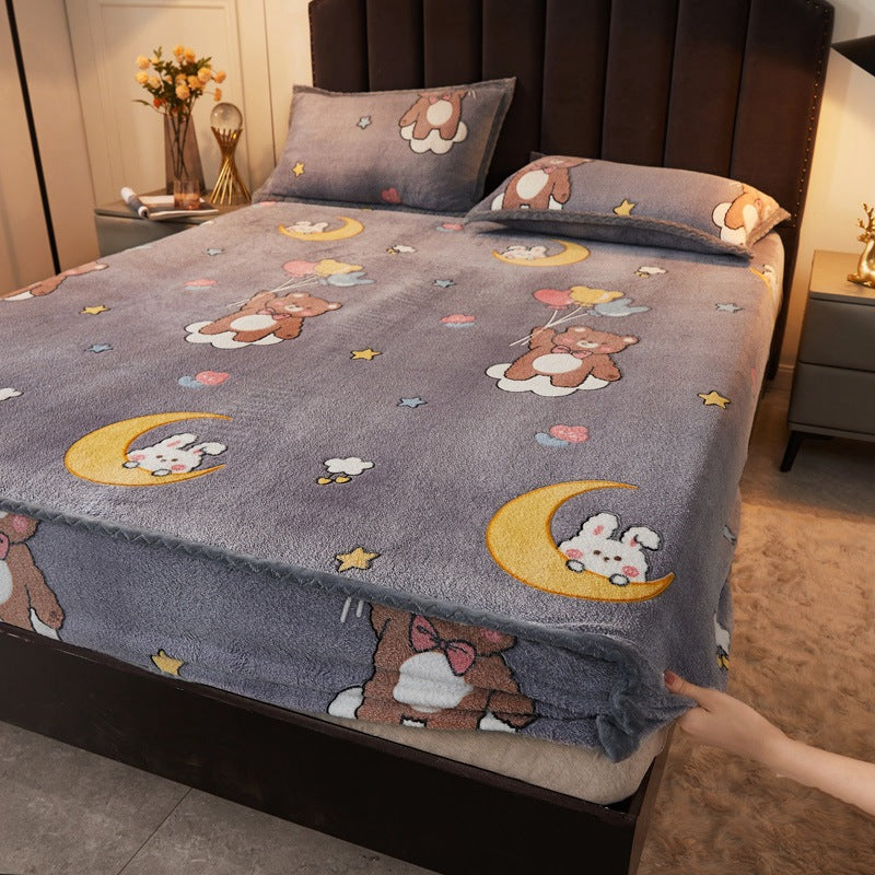 Flannel bedspread with cartoon designs on a bed in a bedroom setting.
