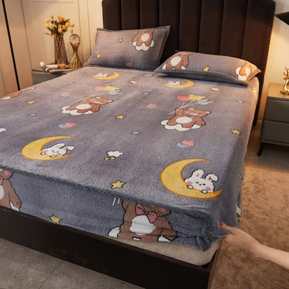 Flannel bedspread with cartoon designs on a bed in a bedroom setting.