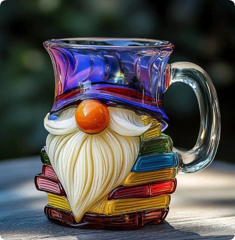 Glass mug shaped like a gnome with a colorful hat on a wooden surface