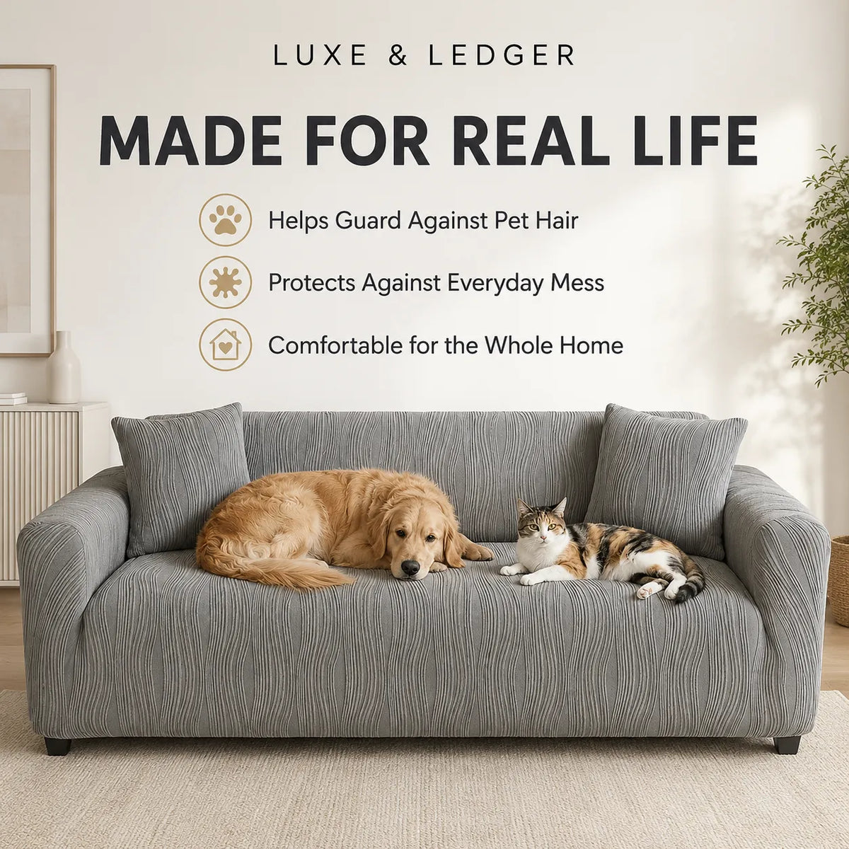 A gray textured slipcover fitted on a three-seat sofa in a bright living room, with a golden retriever lying on the left side and a calico cat lying on the right side. Large text at the top reads 'LUXE & LEDGER MADE FOR REAL LIFE' with three feature icons and descriptions about guarding against pet hair, protecting against everyday mess, and comfort for the whole home.