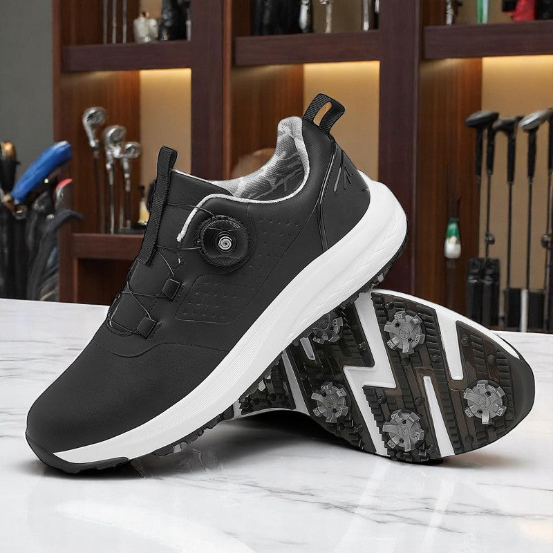 A pair of white golf shoes with a non-slip rubber sole, designed for all-terrain play on a green surface with golf balls and clubs in the background.