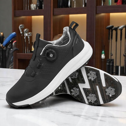 A pair of white golf shoes with a non-slip rubber sole, designed for all-terrain play on a green surface with golf balls and clubs in the background.