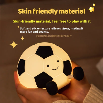 Football-shaped silicone night light held in a hand with text about skin-friendly material.