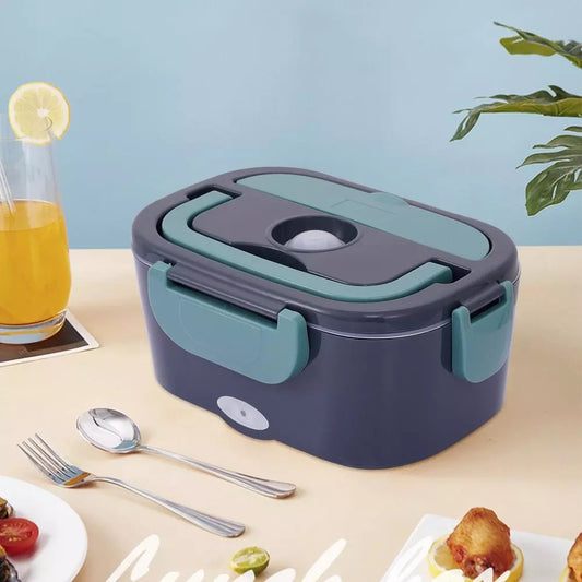 Lunch box with a glass of juice and food on a table