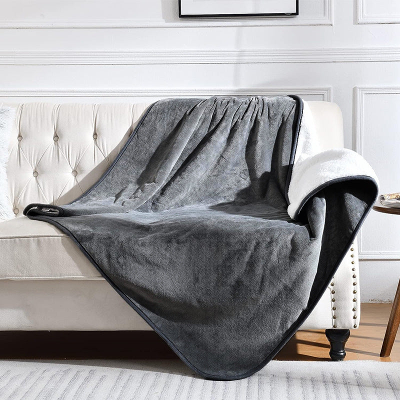 Gray blanket draped over a white armchair in a living room setting.
