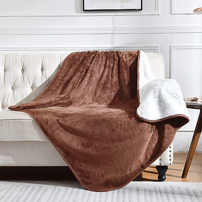Brown blanket draped over a white sofa in a living room setting.