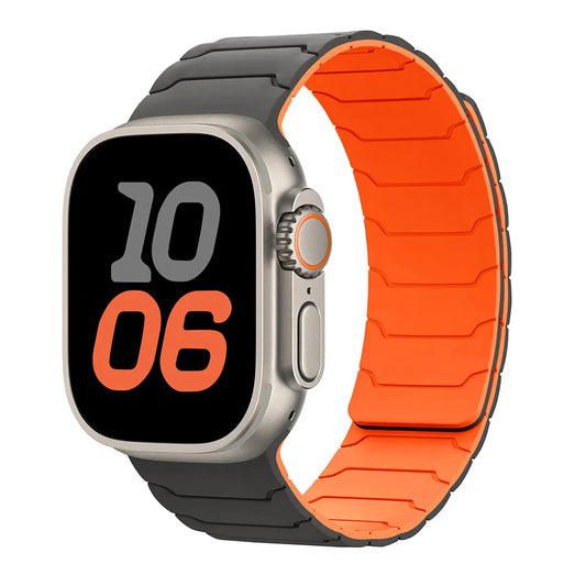 A smartwatch with a silver-toned case and a two-tone band. The band is dark gray on the outside and bright orange on the inside, shown against a plain white background.