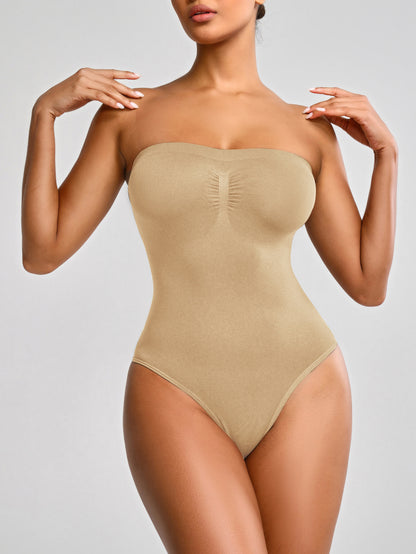 Beige strapless bodysuit worn by a model on a plain background