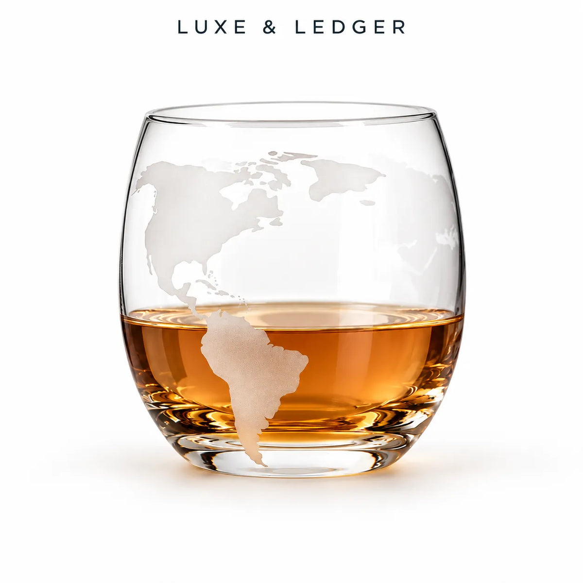 A clear stemless whiskey glass with a frosted world map design, partially filled with amber liquor, on a white background. The brand name 'LUXE & LEDGER' is printed in black at the top of the image.