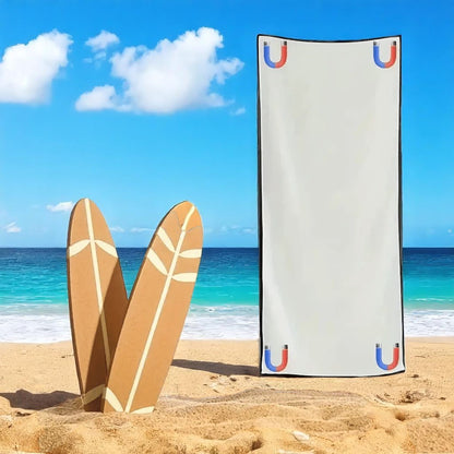 Beach towel with brand logo on a sandy beach with surfboards and ocean view