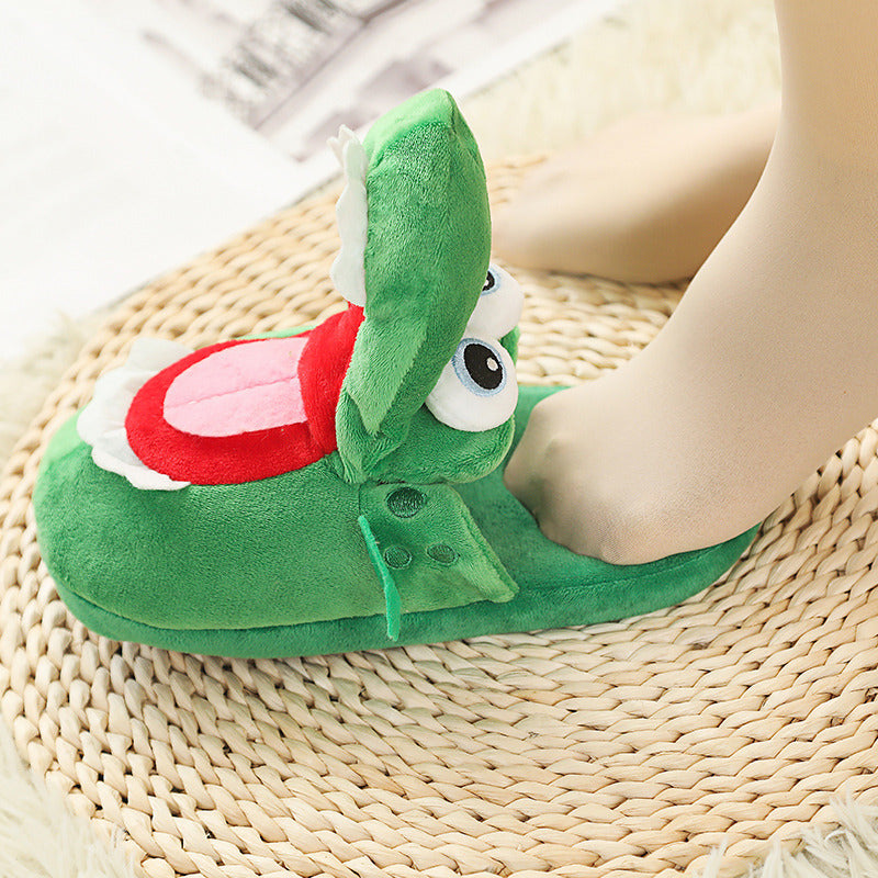 Green cartoonish slipper with a red mouth on a woven mat