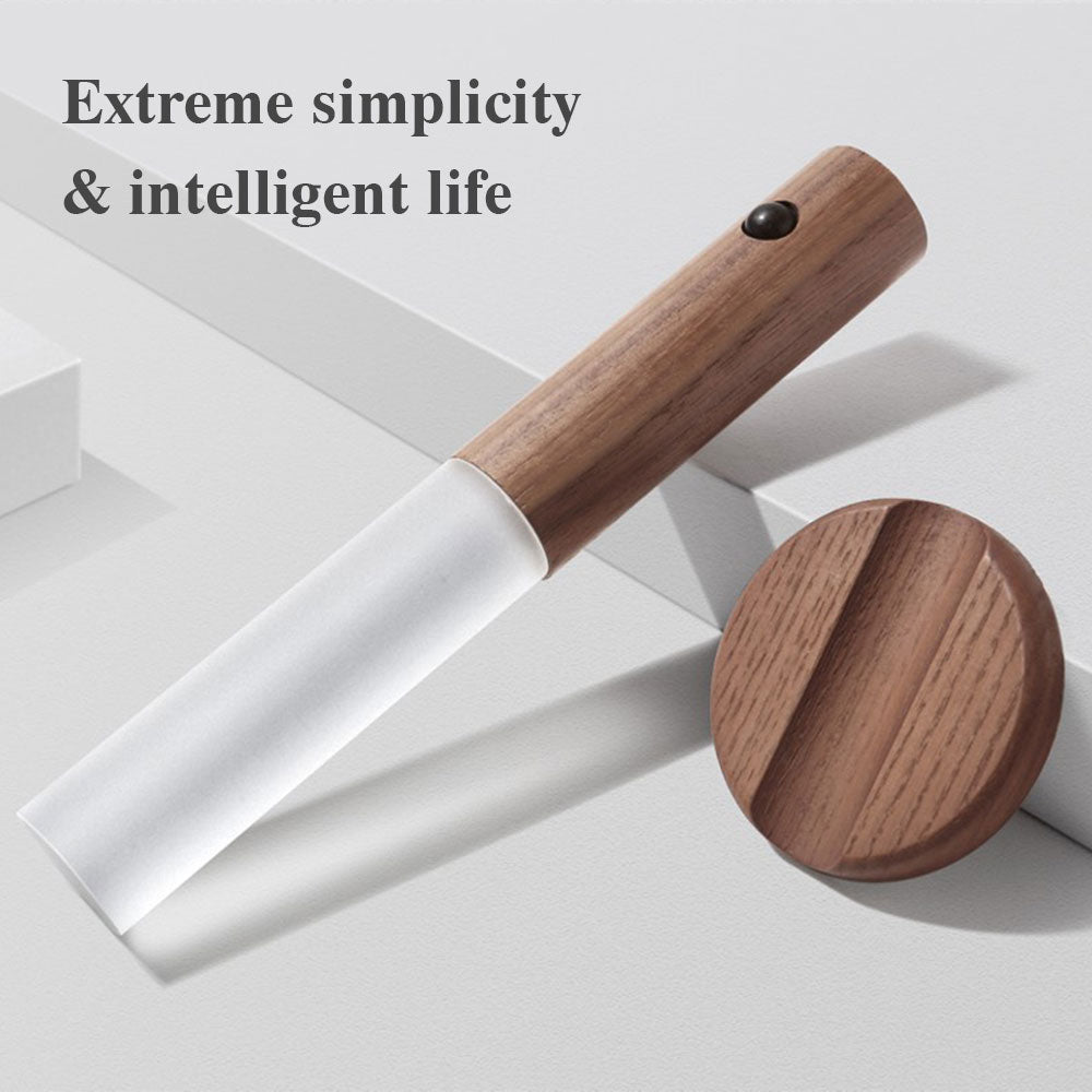White kitchen tool with wooden handle and base on a light gray background, text 'Extreme simplicity & intelligent life' above.