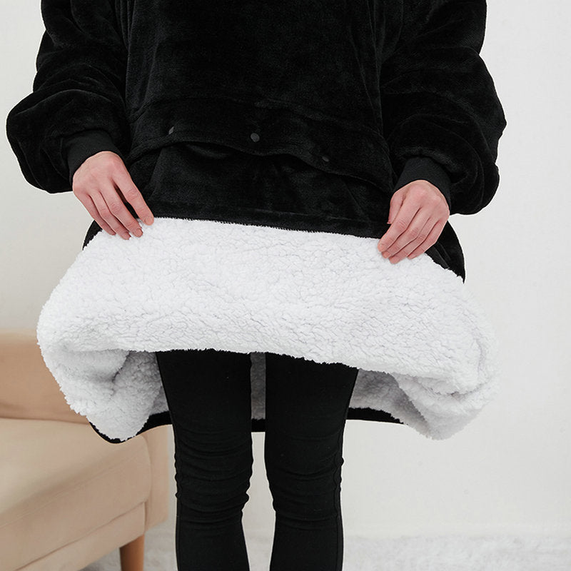 Person holding a white textured blanket against a neutral background