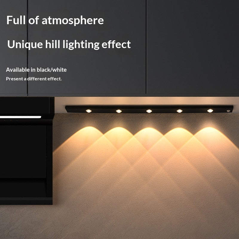 Lighting fixture with unique hill lighting effect on a dark background