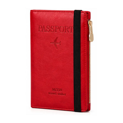 A red faux-leather passport holder and travel wallet with an elastic black band and a gold zipper, shown on a white background.
