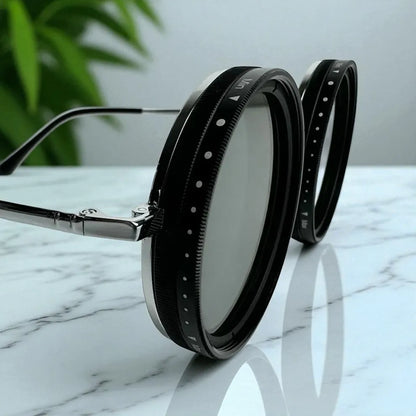Sunglasses with black frames and silver accents on a marble surface