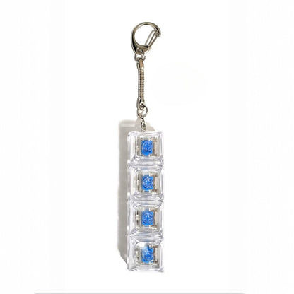 Keychain with embedded blue gemstones on a white background