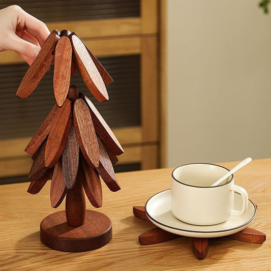 Wooden decorative item resembling a tree on a table with a cup and saucer.